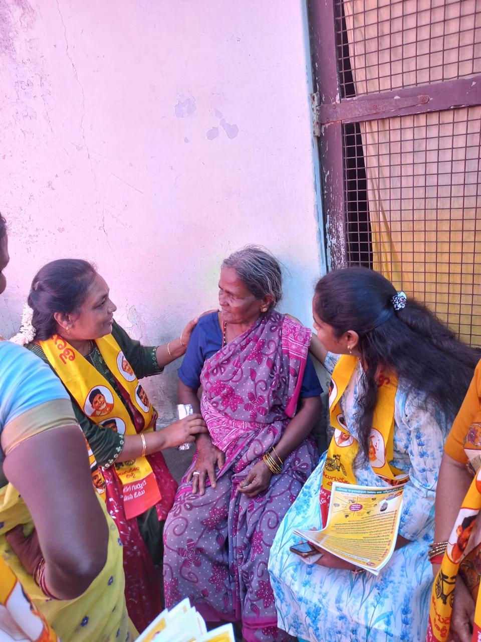 Thejaswi talking with a resident during community outreach