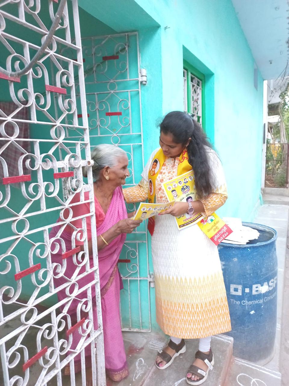 Thejaswi listening to an older resident at her home in Chittoor